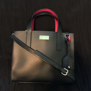 Black Kate Spade purse with hot pink interior